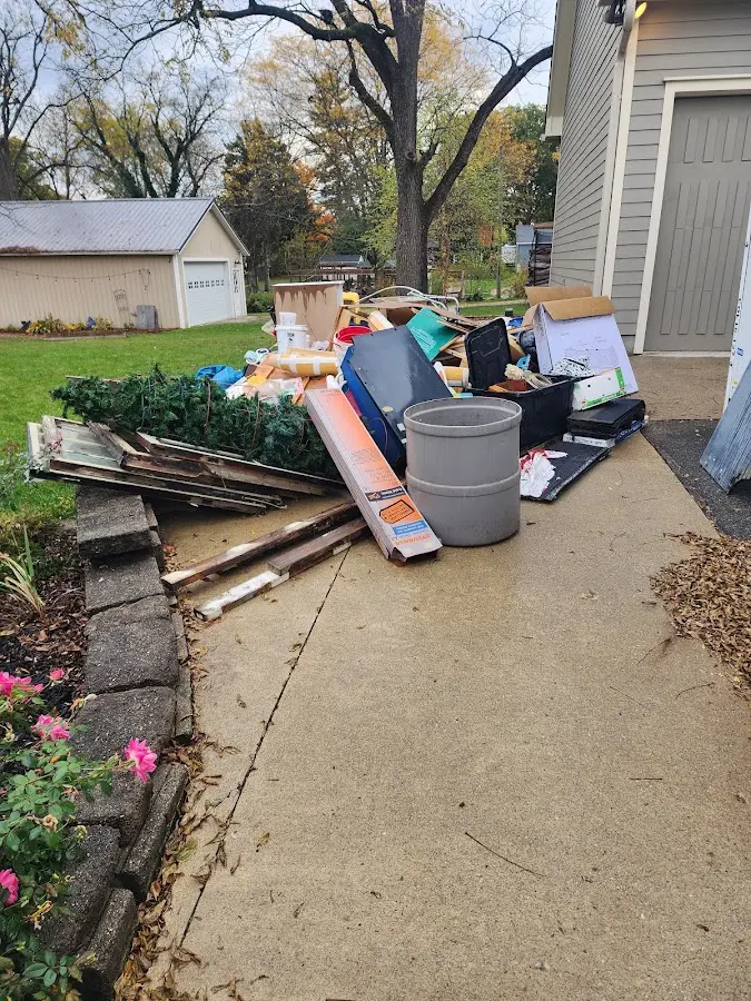 Dumpster being loaded with debris for Estate Cleanout Dumpster Rental in Mayfield